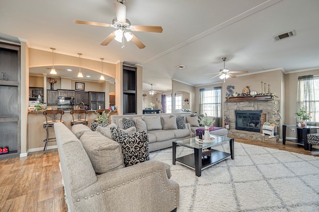 living room with ornamental molding, hardwood / wood-style flooring, and a healthy amount of sunlight