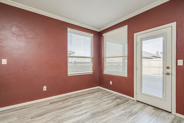 entryway featuring light hardwood / wood-style floors and crown molding