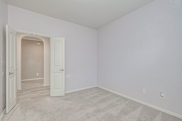 empty room featuring light carpet