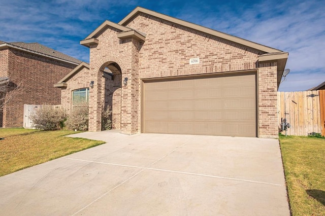 view of front facade with a garage and a front lawn