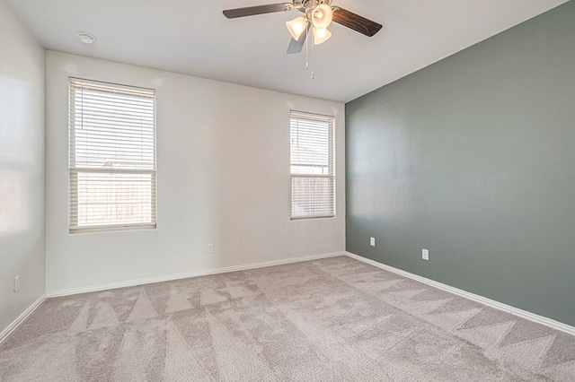 carpeted spare room with ceiling fan