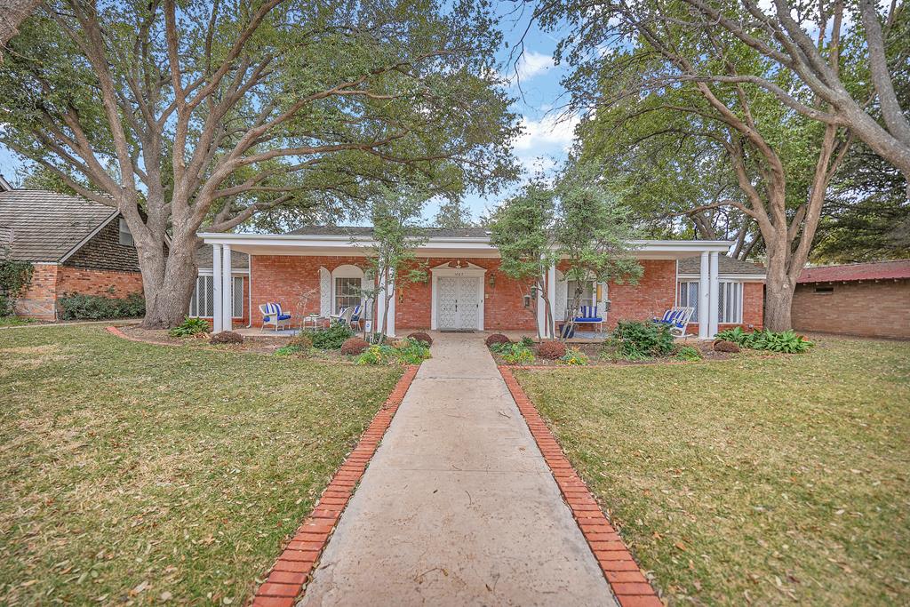 1607 Stanolind Ave, Midland, TX 79705 - view of front of property featuring a front lawn, a porch, and brick siding