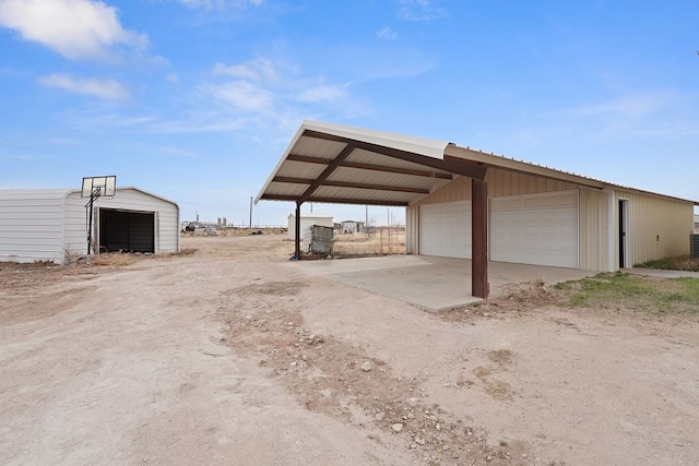 view of car parking featuring a garage and a carport