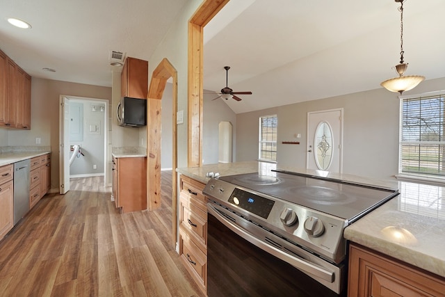 kitchen with lofted ceiling, hanging light fixtures, ceiling fan, stainless steel appliances, and light hardwood / wood-style flooring