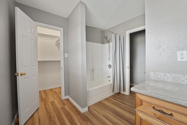 bathroom featuring vanity, hardwood / wood-style floors, and shower / bath combo with shower curtain