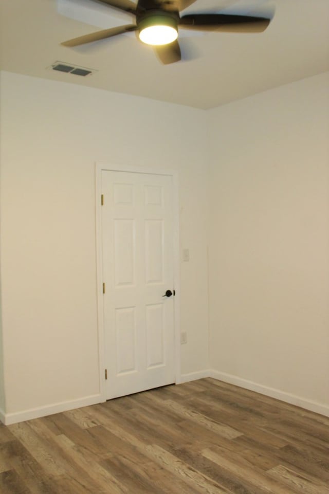 unfurnished room featuring ceiling fan and wood-type flooring