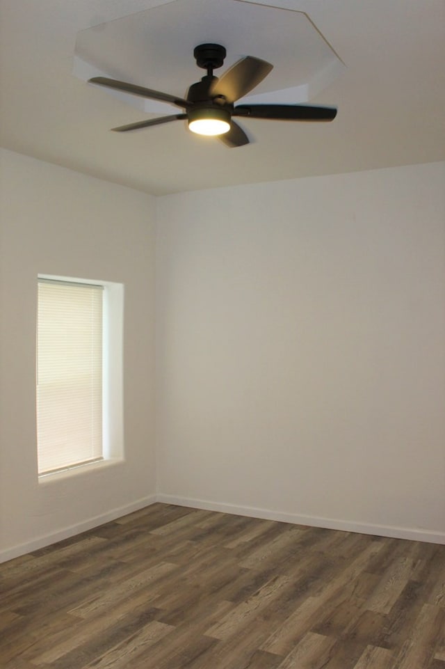 spare room featuring dark hardwood / wood-style floors and ceiling fan