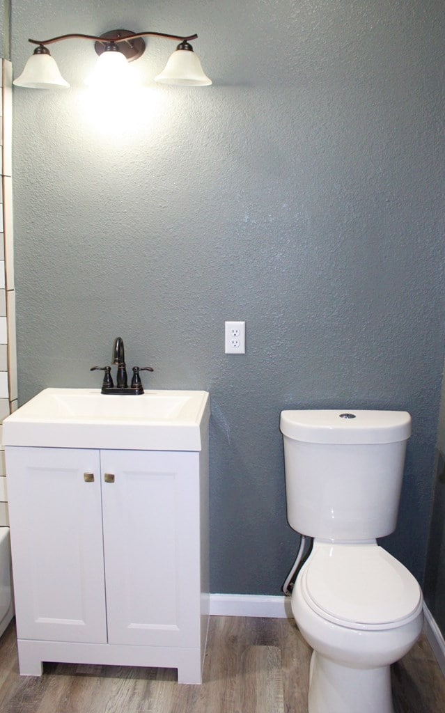 bathroom featuring hardwood / wood-style floors, vanity, and toilet