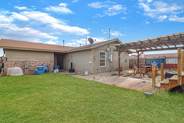 back of house featuring a pergola, a yard, and a deck