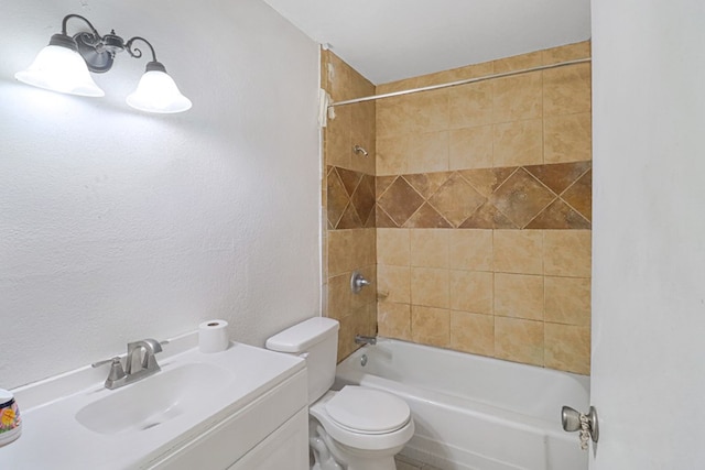 full bathroom featuring tiled shower / bath combo, vanity, and toilet