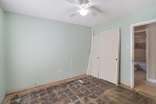 unfurnished bedroom featuring a textured ceiling and ceiling fan