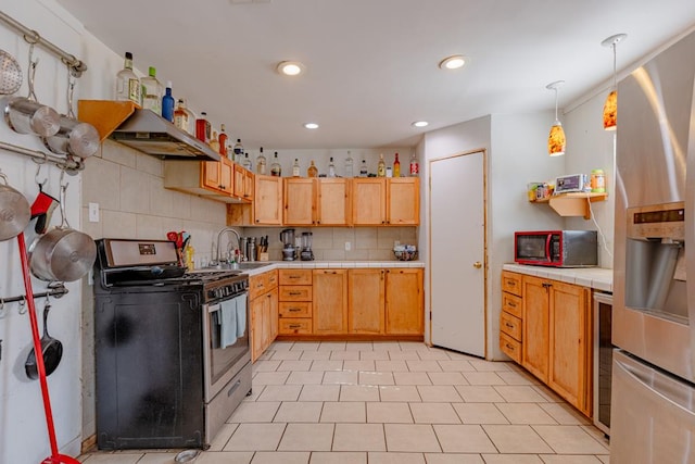 1304 Lynn Ave, Midland, TX 79705 - kitchen with stainless steel appliances, tile countertops, a sink, exhaust hood, and decorative backsplash