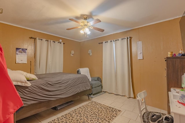 1304 Lynn Ave, Midland, TX 79705 - bedroom with light tile patterned floors, ornamental molding, a ceiling fan, and wooden walls