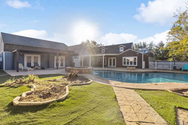 back of house featuring a patio area, french doors, and a pool with hot tub