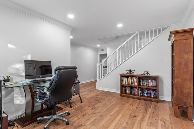 office area with crown molding and light wood-type flooring