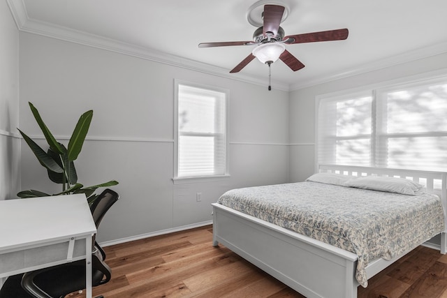 bedroom with ceiling fan, crown molding, and wood-type flooring