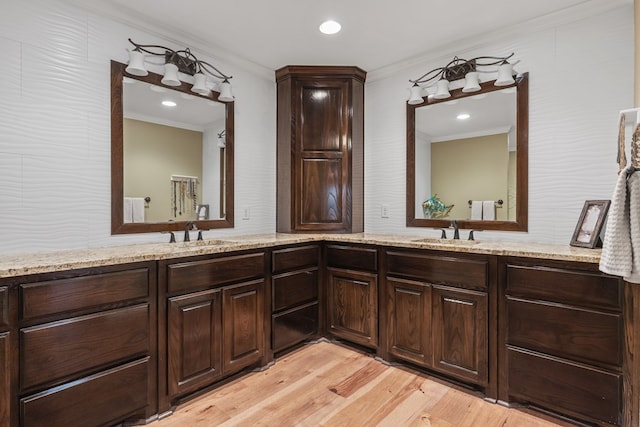 bathroom featuring hardwood / wood-style floors, vanity, and ornamental molding