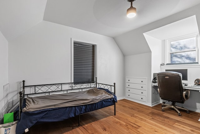 bedroom with light hardwood / wood-style flooring and lofted ceiling