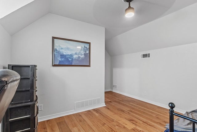 bonus room with wood-type flooring and lofted ceiling