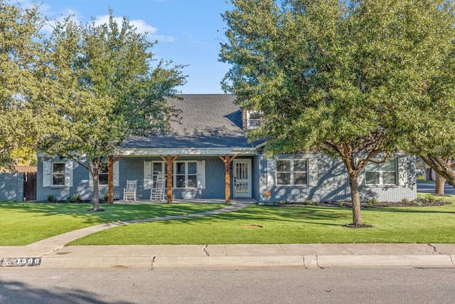 view of front of home with a front yard and a porch