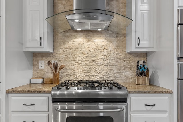 kitchen with island exhaust hood, gas range, tasteful backsplash, and white cabinetry