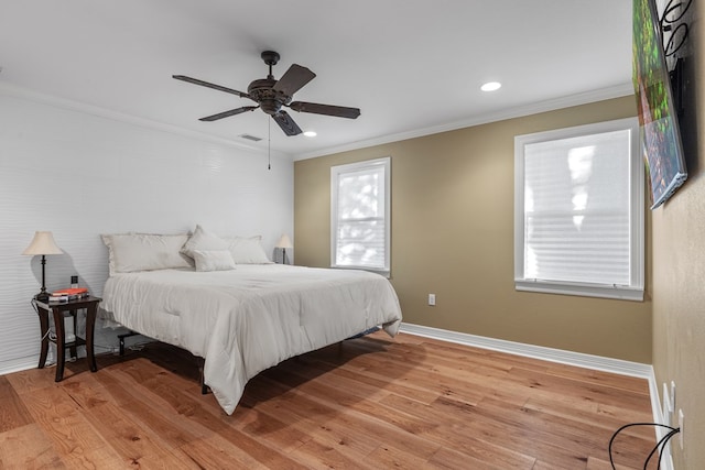 bedroom with wood-type flooring, ceiling fan, and ornamental molding