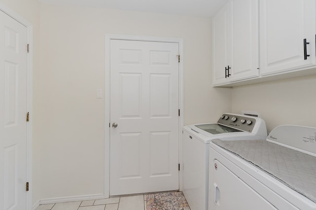2429 S County Rd 1120, Midland, TX 79706 - laundry room featuring separate washer and dryer, cabinet space, and light tile patterned floors