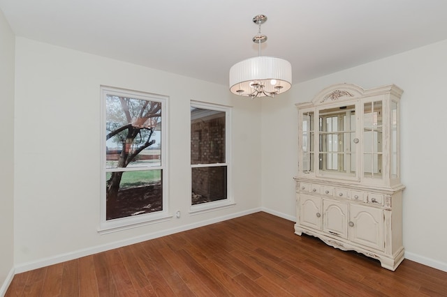 2429 S County Rd 1120, Midland, TX 79706 - unfurnished dining area with dark wood finished floors and a chandelier