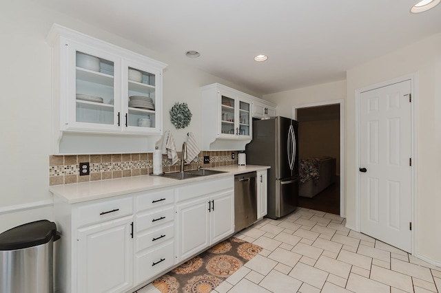 2429 S County Rd 1120, Midland, TX 79706 - kitchen with stainless steel appliances, backsplash, light countertops, white cabinetry, and recessed lighting