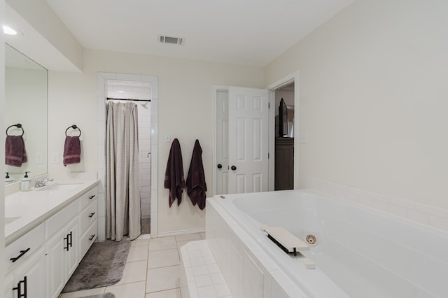 2429 S County Rd 1120, Midland, TX 79706 - bathroom featuring a tub with jets, double vanity, tile patterned floors, and a tile shower