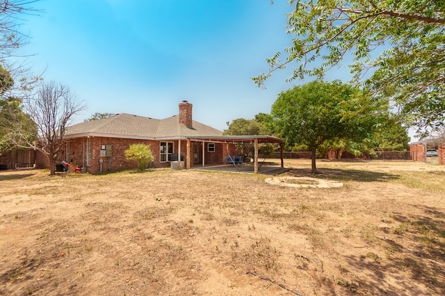 2429 S County Rd 1120, Midland, TX 79706 - back of house featuring a patio, a chimney, and brick siding