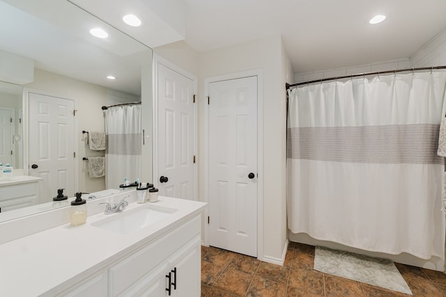2429 S County Rd 1120, Midland, TX 79706 - full bath with vanity, stone finish floors, recessed lighting, and curtained shower