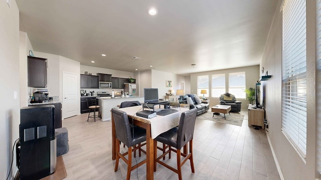 dining space with light hardwood / wood-style flooring