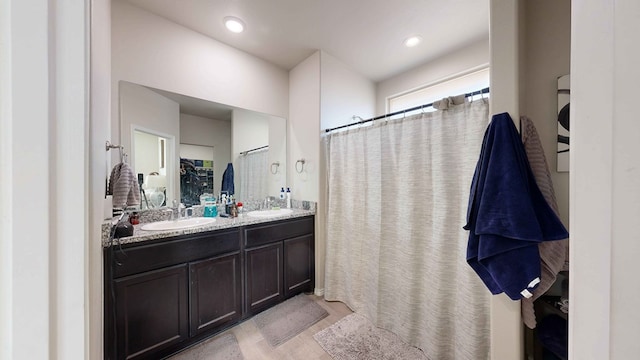 bathroom with walk in shower and vanity