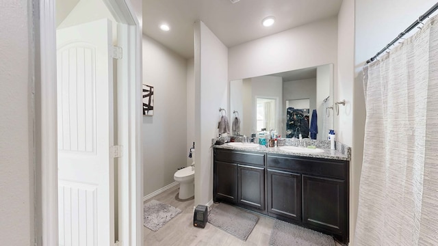 bathroom featuring hardwood / wood-style floors, toilet, and vanity