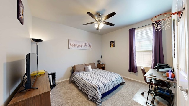 carpeted bedroom with ceiling fan and radiator heating unit