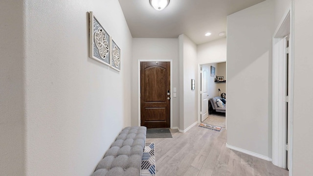 hallway with light hardwood / wood-style floors