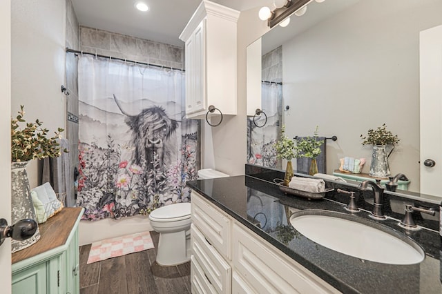 2900 S County Rd 1092, Midland, TX 79706 - full bathroom with vanity, recessed lighting, toilet, wood finished floors, and shower / tub combo