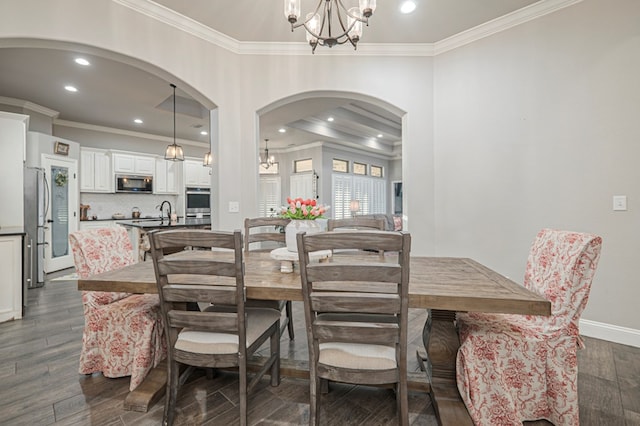 2900 S County Rd 1092, Midland, TX 79706 - dining area featuring arched walkways, an inviting chandelier, dark wood-style flooring, ornamental molding, and recessed lighting