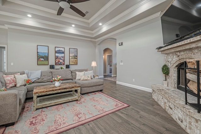 2900 S County Rd 1092, Midland, TX 79706 - living area with ceiling fan, arched walkways, ornamental molding, a brick fireplace, and dark wood-style floors