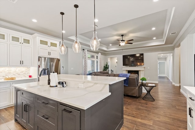 3100 Fairfield Ln, Midland, TX 79705 - kitchen with stainless steel fridge, crown molding, a ceiling fan, a tray ceiling, and white cabinetry