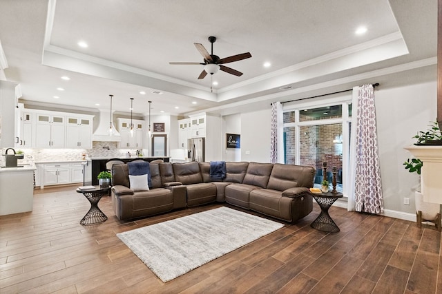 3100 Fairfield Ln, Midland, TX 79705 - living area featuring a tray ceiling, a ceiling fan, wood finished floors, ornamental molding, and recessed lighting