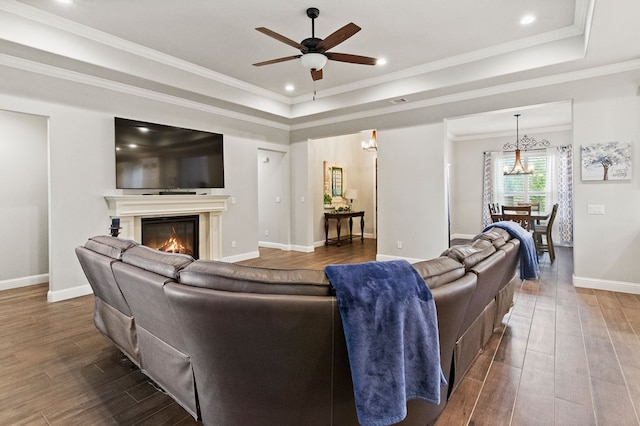 3100 Fairfield Ln, Midland, TX 79705 - living area featuring dark wood-style flooring, a tray ceiling, ceiling fan, a chandelier, and recessed lighting
