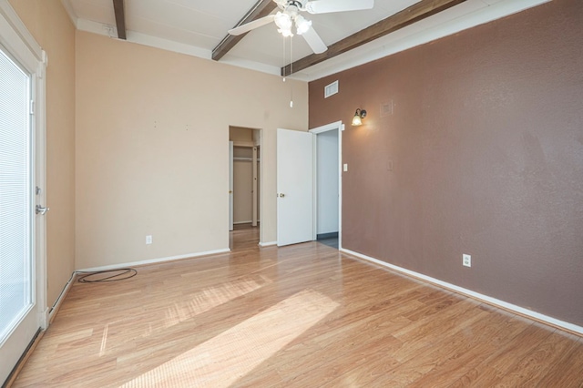 unfurnished bedroom with ceiling fan, light hardwood / wood-style flooring, and beamed ceiling