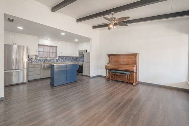 kitchen featuring a kitchen island, white cabinetry, backsplash, dark hardwood / wood-style flooring, and stainless steel appliances