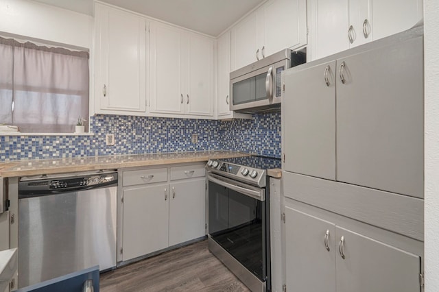 kitchen featuring backsplash, stainless steel appliances, dark hardwood / wood-style floors, and white cabinets