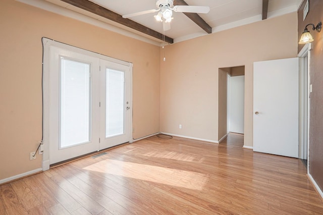 spare room with beamed ceiling, ceiling fan, and light wood-type flooring