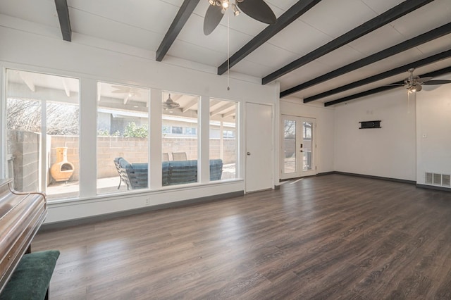 unfurnished living room featuring beamed ceiling, ceiling fan, and dark hardwood / wood-style floors