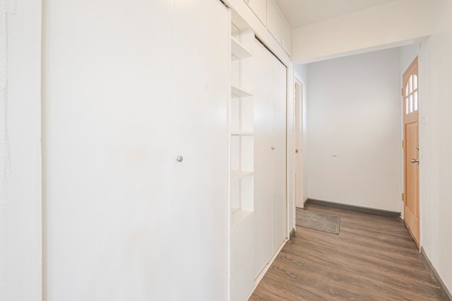 corridor featuring dark hardwood / wood-style flooring