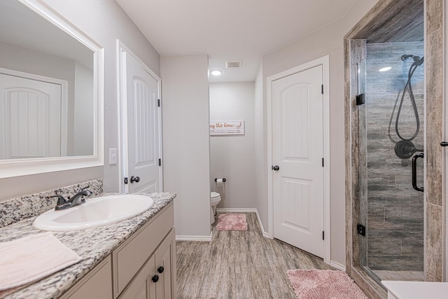 2812 Carver, Midland, TX 79705 - full bath featuring vanity, a shower stall, wood finished floors, toilet, and baseboards